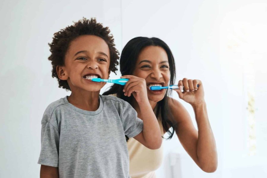Learning,,Mother,And,Son,Brushing,Teeth,,Dental,Hygiene,And,Wellness