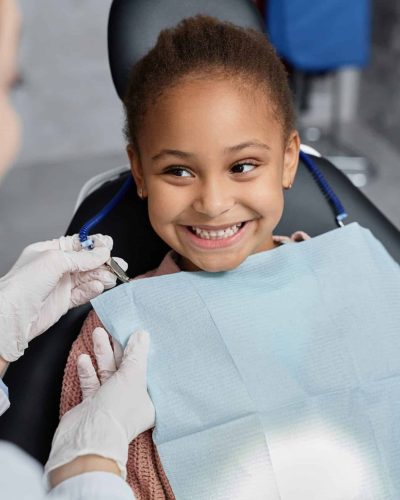 Portrait,Of,Smiling,Little,Girl,In,Dental,Chair,With,Nurse